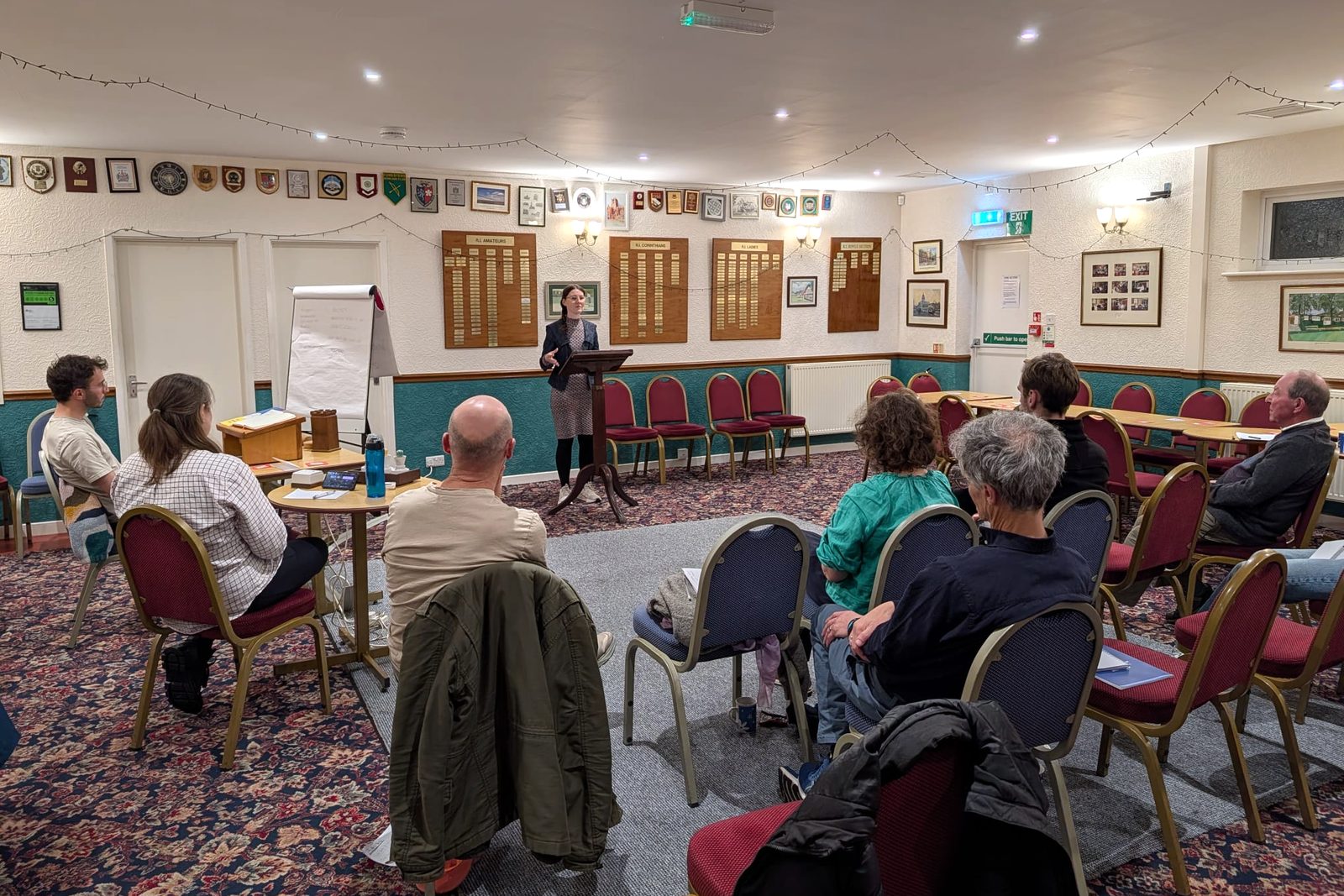 A member giving a speech from a lectern to a small seated audience at a York Speakers Club meeting